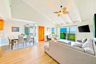 a living room with a couch and a table at Condo in Newport Beach with Private Balcony and Ideal Location by the Pier in Newport Beach