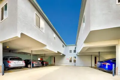 a large parking lot with cars parked in it at Balboa Peninsula Hidden Gem with Private Balcony & Stunning Views in Newport Beach