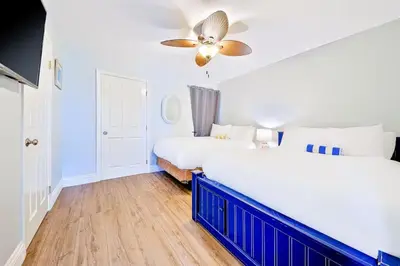 a bedroom with two beds and a ceiling fan at Oceanfront Condo in Newport Beach with Private Balcony and Perfect Location by the Pier in Newport Beach
