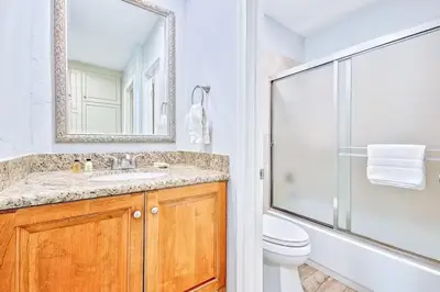 a bathroom with a toilet and a sink and a shower at Oceanfront Condo in Newport Beach with Private Balcony and Perfect Location by the Pier in Newport Beach