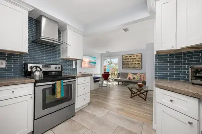 a kitchen with white cabinets and a stove at Stunning Casa Surf House in Newport with Parking Stunning Casa Surf House in Newport in Newport Beach