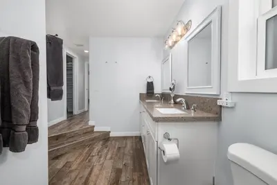 a white bathroom with a sink and a mirror at Giant Newport Duplex - Surf, Sand, Playground, Parking in Newport Beach