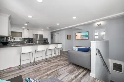 a kitchen and living room with a couch and a counter at Perfect Surf Casa in Newport Near Beach and Pier in Newport Beach