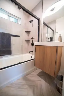 a bathroom with a tub and a sink and a shower at Modern 1 BR Cottage Steps 2Beach in San Diego