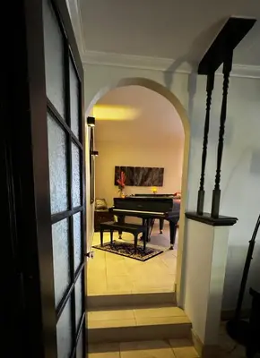 an archway leading into a room with a pool table at Secluded Paradise Oasis with Gorgeous Pool in El Cajon