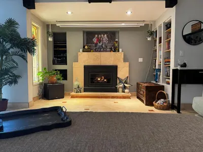 a living room with a fireplace and a couch at Secluded Paradise Oasis with Gorgeous Pool in El Cajon