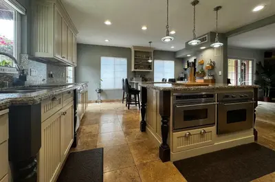 a kitchen with an island in the middle of it at Secluded Paradise Oasis with Gorgeous Pool in El Cajon