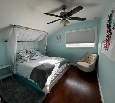 a bedroom with a bed and a ceiling fan at Secluded Paradise Oasis with Gorgeous Pool in El Cajon