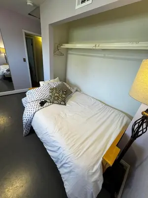 a large white bed in a room with a lamp at Secluded Paradise Oasis with Gorgeous Pool in El Cajon
