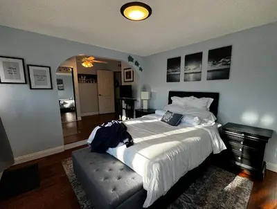 a bedroom with a large bed and a dining room at Secluded Paradise Oasis with Gorgeous Pool in El Cajon