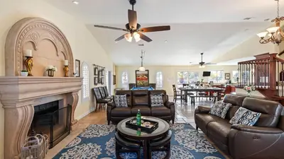 a living room with leather furniture and a fireplace at Chardonnay Charm by AvantStay Luxe Group Retreat w Pool Mins to Wineries in Country Road Estates