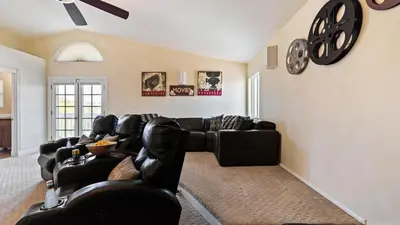 a living room with leather furniture and a clock on the wall at Chardonnay Charm by AvantStay Luxe Group Retreat w Pool Mins to Wineries in Country Road Estates