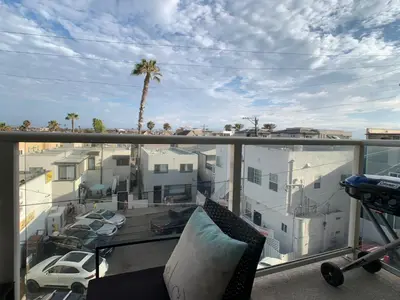 a balcony with a view of a parking lot at Ocean, Bay, Downtown, and City view Condo, Few steps from the ocean in San Diego