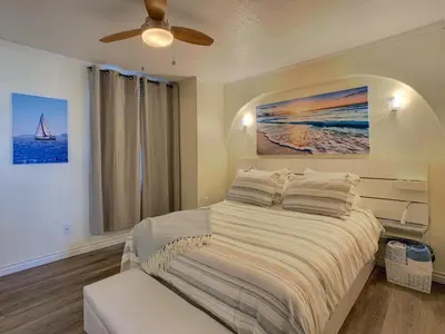 a bedroom with a bed and a ceiling fan at Ocean, Bay, Downtown, and City view Condo, Few steps from the ocean in San Diego