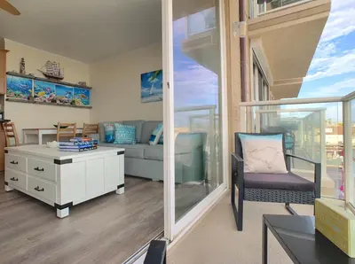 a living room with a couch and a table at Ocean, Bay, Downtown, and City view Condo, Few steps from the ocean in San Diego