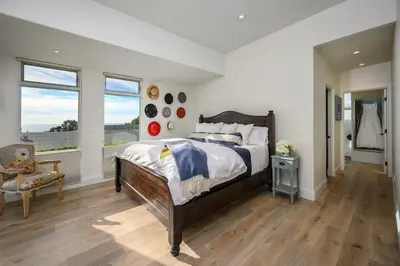 a bedroom with a large bed and a window at 4BR Luxury Del Mar Beach House with Ocean Views in San Diego