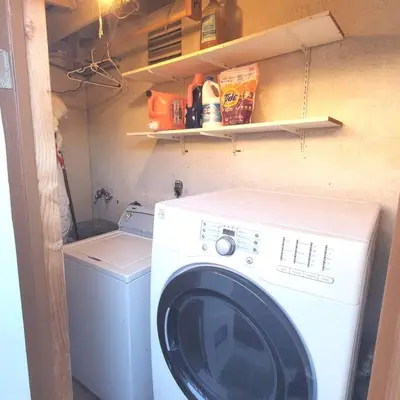 a washing machine and a washer in a small room at SanDiego Insider's Coastal Bliss and Urban Wonders in San Diego