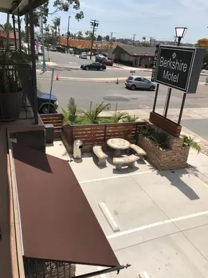 a sign for a restaurant in a parking lot at Berkshire Motor Hotel in San Diego