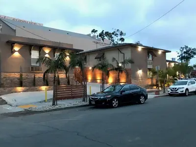 a black car parked in front of a building at Berkshire Motor Hotel in San Diego