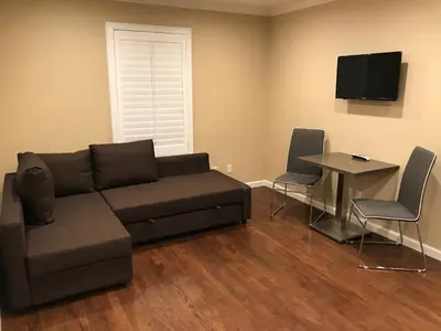 a living room with a couch and a table at Berkshire Motor Hotel in San Diego