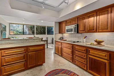 a kitchen with wooden cabinets and a counter top at La Jolla Gem condo in San Diego