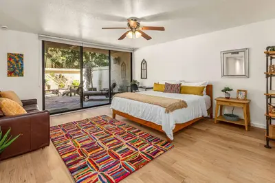 a bedroom with a bed and a ceiling fan at La Jolla Gem condo in San Diego
