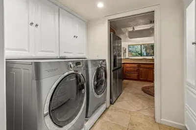 a kitchen with a washer and dryer in a room at La Jolla Gem condo in San Diego
