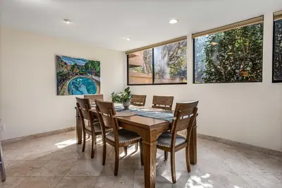 a dining room with a wooden table and chairs at La Jolla Gem condo in San Diego