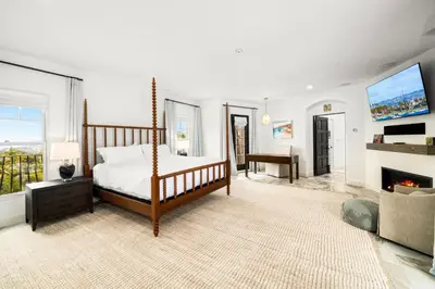 a bedroom with a bed and a fireplace at Grand Mediterranean Villa in La Jolla Hillside in San Diego