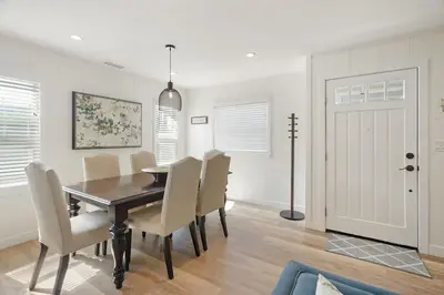 a dining room with a table and chairs at Coastal Palm Haven - With Hot Tub in Carlsbad