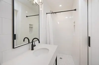 a white bathroom with a sink and a shower at Coastal Palm Haven - With Hot Tub in Carlsbad