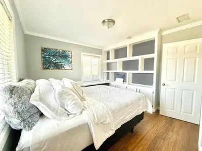 a bedroom with a white bed and a window at The Cozy Ranch Retreat in San Diego
