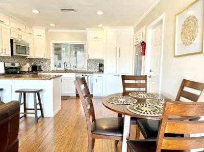 a kitchen and dining room with a table and chairs at The Cozy Ranch Retreat in San Diego