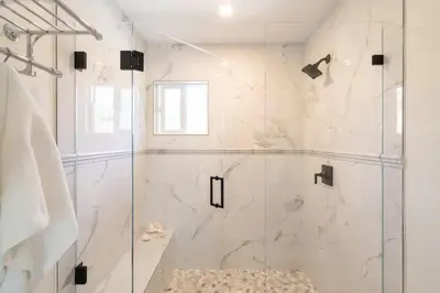 a bathroom with a shower with a glass door at Designer Family Home with Resort-Style Oasis in San Diego