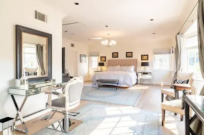 a bedroom with a bed and a desk with a mirror at Luxurious Family 5 Bedroom Getaway in San Diego