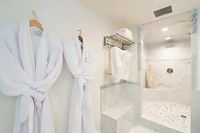 a dressing room with white robes and a mirror at Luxurious Family 5 Bedroom Getaway in San Diego