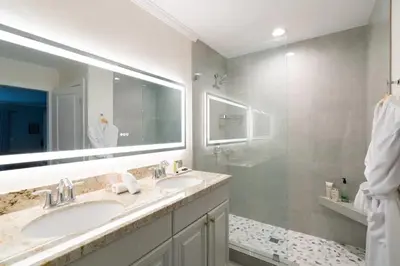 a bathroom with two sinks and a large mirror at Luxurious Family 5 Bedroom Getaway in San Diego