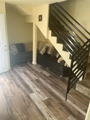 a living room with a couch under the stairs at Casa Mesa in San Diego