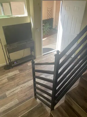 a staircase with a television and a door with a porch at Casa Mesa in San Diego