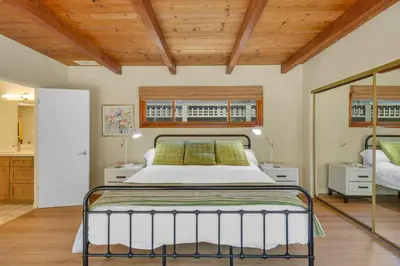 a bedroom with a bed and a wooden ceiling at Pacific Views Retreat - Rooftop Deck, Game Room, Fire Pit & Cozy Backyard! in San Diego