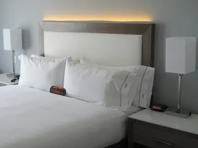 a white bed with white pillows and two lamps at Holiday Inn Express & Suites San Diego - Mission Valley by IHG in San Diego