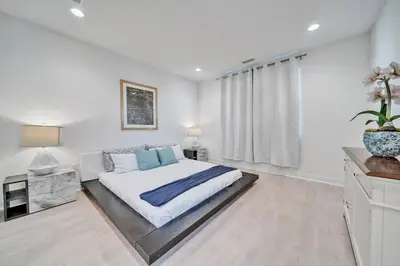 a white bedroom with a bed and a window at Dreamy Bloom Enclave Irivne LA RMV in American Display Heliport