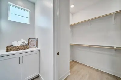a walk in closet with white walls and a window at Dreamy Bloom Enclave Irivne LA RMV in American Display Heliport