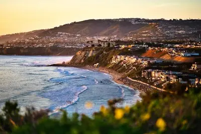 a view of a beach with buildings and the ocean at Dreamy Bloom Enclave Irivne LA RMV in American Display Heliport