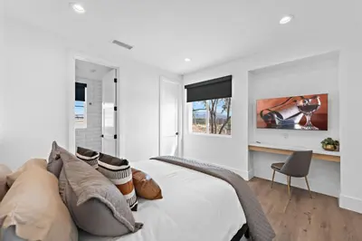 a white bedroom with a bed and a chair at Vaquero by Fieldtrip Modern Wine Country Resort in Temecula