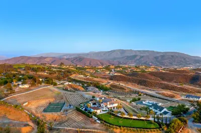 an aerial view of a city with mountains in the background at Vaquero by Fieldtrip Modern Wine Country Resort in Temecula