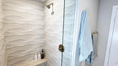 a shower with a glass door in a bathroom at Ocean Views Beach House - 40 PCT Off Monthly in San Clemente
