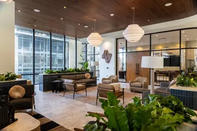 a lobby with chairs and tables and windows at Kasa Little Italy San Diego in San Diego