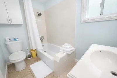 a bathroom with a toilet and a tub and a sink at Charming Ocean Beach 2BR in San Diego