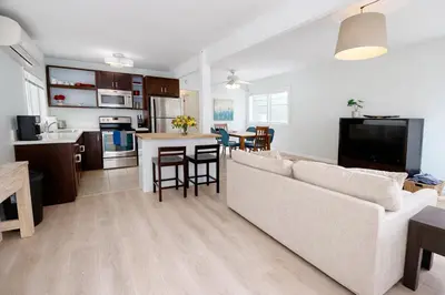 a living room and kitchen with a couch and a table at Charming Ocean Beach 2BR in San Diego